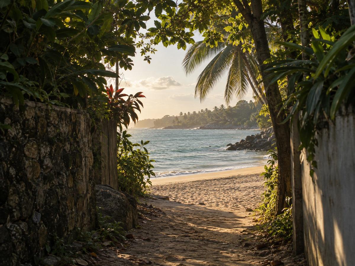 Glimpse of Unawatuna Beach after a short garden-lane walk, late afternoon haze